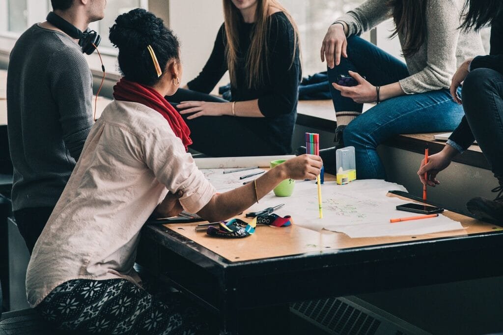 Signs of grooming in teenagers can be especially hard to spot - group of teenagers sitting and chatting