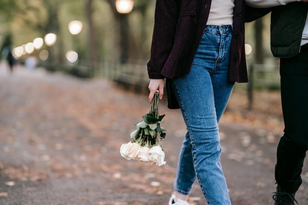 Signs of grooming in adults can be challenging to spot - woman holding bouquet of flowers